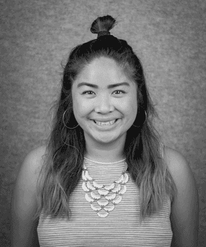 A black & white portrait of Stile team member Makeila Reyes smiling at the camera